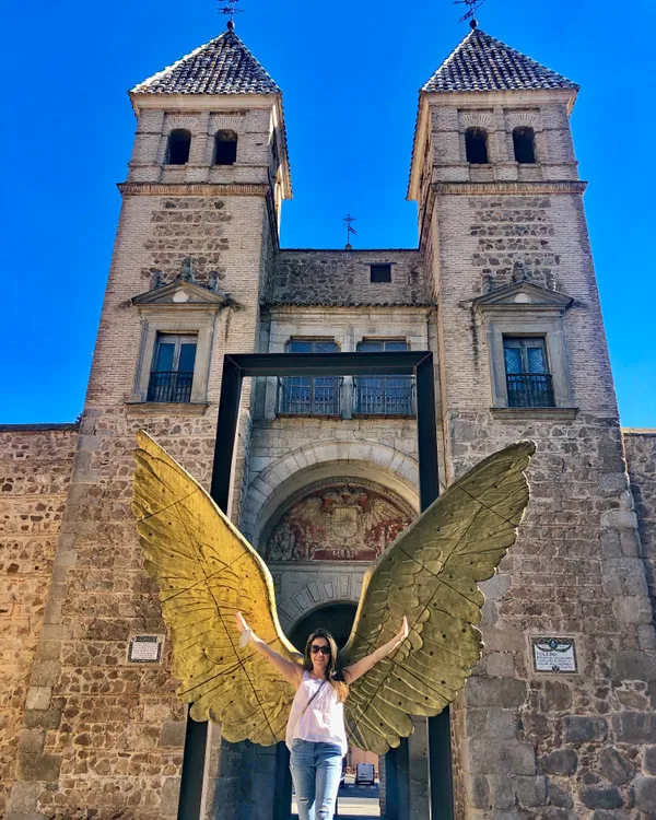 Adriana at the top of Segovia Cathedral with the city skyline behind her